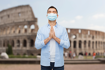 Image showing praying man wearing medical mask in italy