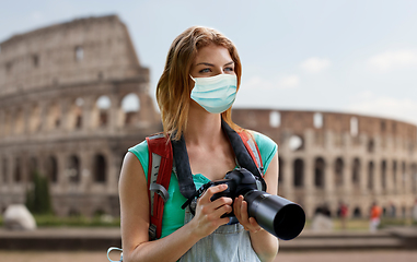 Image showing happy woman with backpack and camera outdoors