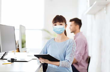 Image showing asian woman in protective medical mask at office