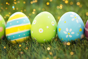 Image showing row of colored easter eggs on artificial grass