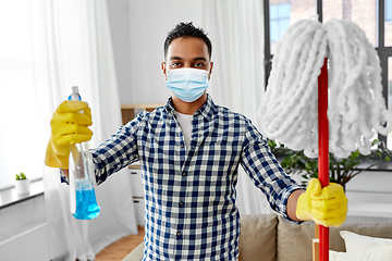 Image showing asian woman in protective mask cleaning home