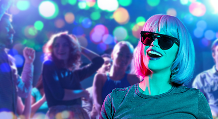 Image showing happy woman in pink wig and sunglasses at party