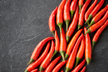 Image showing red chili or cayenne pepper on slate stone surface