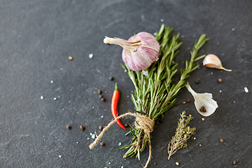 Image showing rosemary, garlic and chili pepper on stone surface