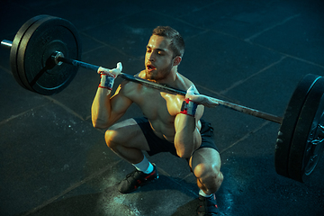 Image showing Caucasian man practicing in weightlifting in gym