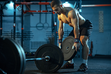 Image showing Caucasian man practicing in weightlifting in gym