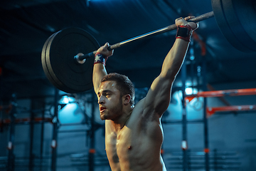 Image showing Caucasian man practicing in weightlifting in gym