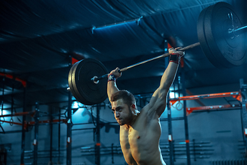 Image showing Caucasian man practicing in weightlifting in gym