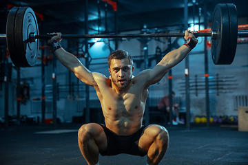 Image showing Caucasian man practicing in weightlifting in gym