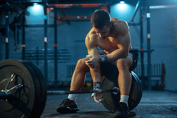 Image showing Caucasian man practicing in weightlifting in gym