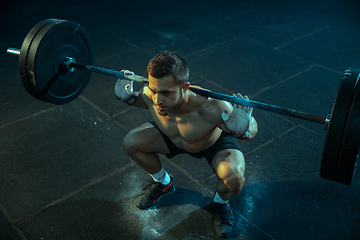 Image showing Caucasian man practicing in weightlifting in gym