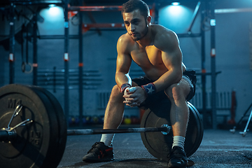 Image showing Caucasian man practicing in weightlifting in gym