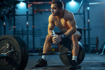 Image showing Caucasian man practicing in weightlifting in gym