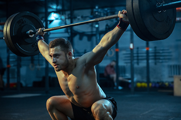 Image showing Caucasian man practicing in weightlifting in gym