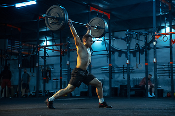 Image showing Caucasian man practicing in weightlifting in gym