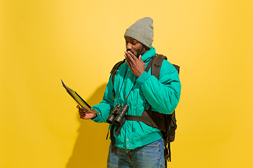 Image showing Full length portrait of a cheerful young african tourist guy isolated on yellow background