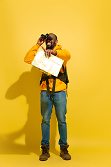 Image showing Full length portrait of a cheerful young african tourist guy isolated on yellow background