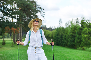 Image showing young woman with nordic walk pols