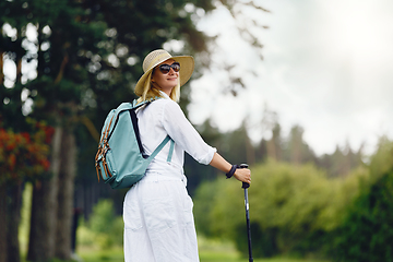 Image showing young woman with nordic walk pols