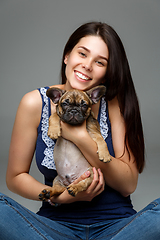 Image showing girl with french bulldog puppy