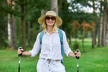 Image showing young woman with nordic walk pols