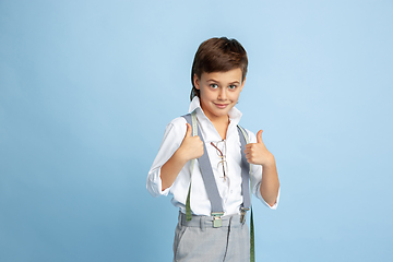 Image showing Little boy dreaming about future profession of seamstress