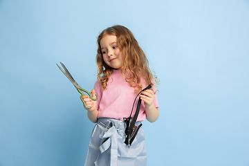 Image showing Little girl dreaming about future profession of seamstress