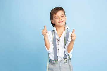 Image showing Little boy dreaming about future profession of seamstress