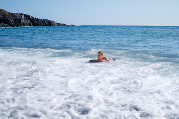 Image showing girl swimming on board in ocean