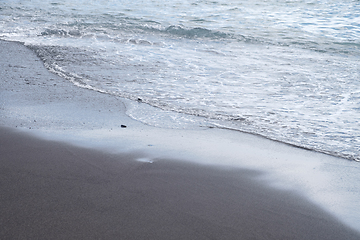 Image showing ocean water on black sand