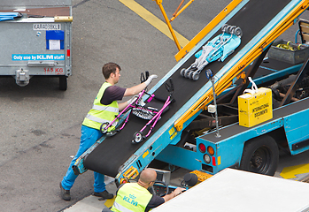 Image showing AMSTERDAM, NETHERLANDS - JUNE 29, 2017: Loading luggage in airpl