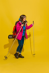 Image showing Full length portrait of a cheerful young caucasian tourist girl isolated on yellow background