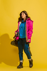 Image showing Full length portrait of a cheerful young caucasian tourist girl isolated on yellow background