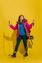 Image showing Full length portrait of a cheerful young caucasian tourist girl isolated on yellow background