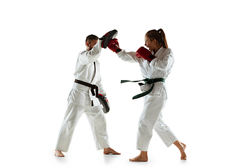 Image showing Junior in kimono practicing hand-to-hand combat with coach, martial arts