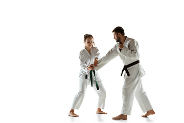 Image showing Junior in kimono practicing hand-to-hand combat with coach, martial arts