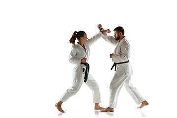 Image showing Junior in kimono practicing hand-to-hand combat with coach, martial arts