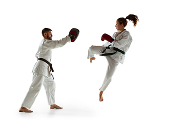 Image showing Junior in kimono practicing hand-to-hand combat with coach, martial arts