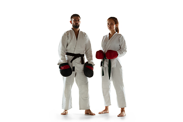 Image showing Junior in kimono practicing hand-to-hand combat with coach, martial arts