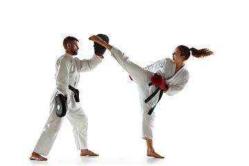 Image showing Junior in kimono practicing hand-to-hand combat with coach, martial arts