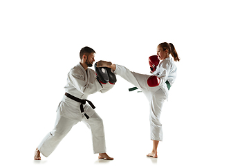 Image showing Junior in kimono practicing hand-to-hand combat with coach, martial arts