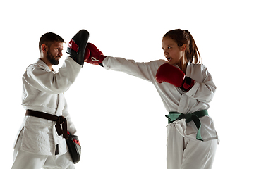 Image showing Junior in kimono practicing hand-to-hand combat with coach, martial arts