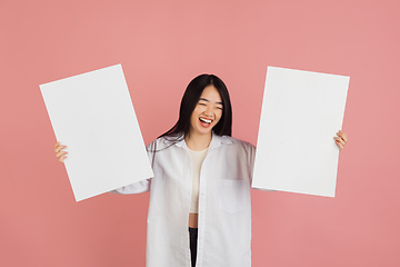 Image showing Asian young woman\'s portrait on pink studio background. Concept of human emotions, facial expression, youth, sales, ad.