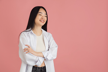 Image showing Asian young woman\'s portrait on pink studio background. Concept of human emotions, facial expression, youth, sales, ad.