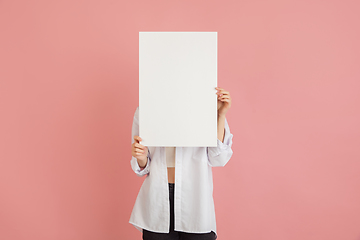 Image showing Asian young woman\'s portrait on pink studio background. Concept of human emotions, facial expression, youth, sales, ad.