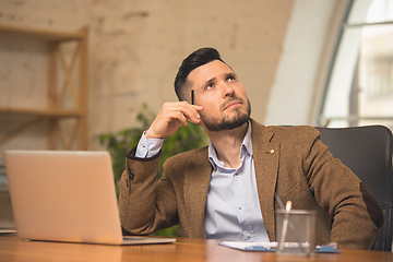 Image showing Man working in modern office using devices and gadgets during creative meeting.