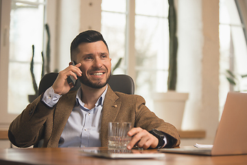 Image showing Man working in modern office using devices and gadgets during creative meeting.