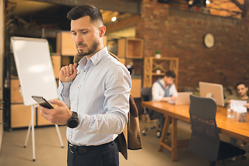 Image showing Man working in modern office using devices and gadgets during creative meeting.