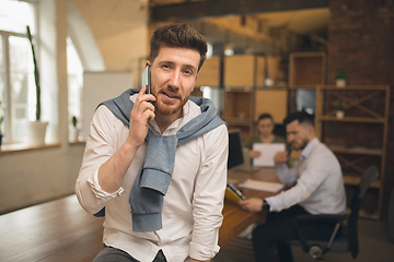 Image showing Man working in modern office using devices and gadgets during creative meeting.