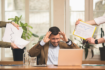 Image showing Man working in modern office using devices and gadgets during creative meeting.